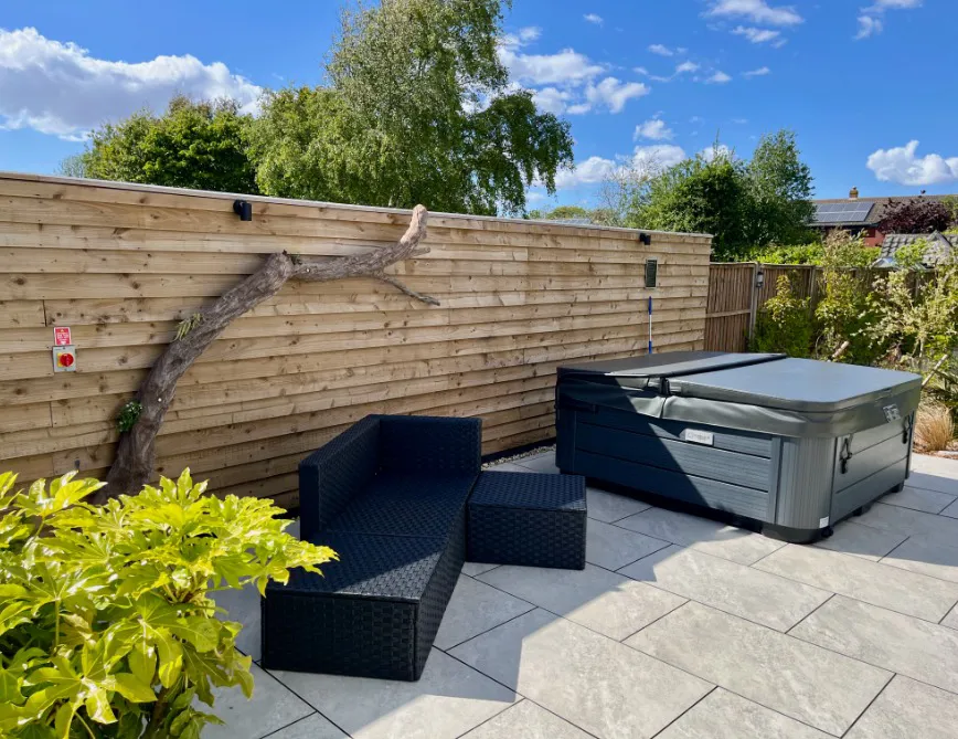 Large twisted driftwood feature beside the private hot tub garden at High Beach holiday cottage in Berrow Somerset