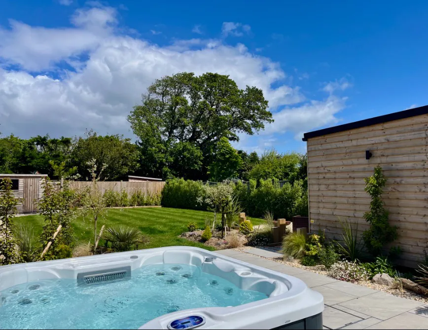 Private hot tub overlooking the enclosed garden at High Beach holiday cottage in Berrow Somerset