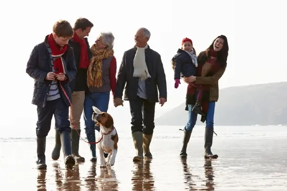 Family enjoying an autumn beach walk with their dog near Berrow and Brean on the Somerset coast