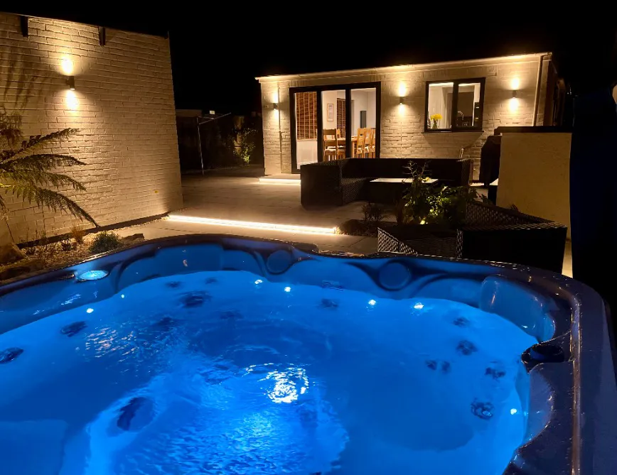 Hot tub at night looking towards High Beach holiday cottage in Berrow near Brean on the Somerset coast